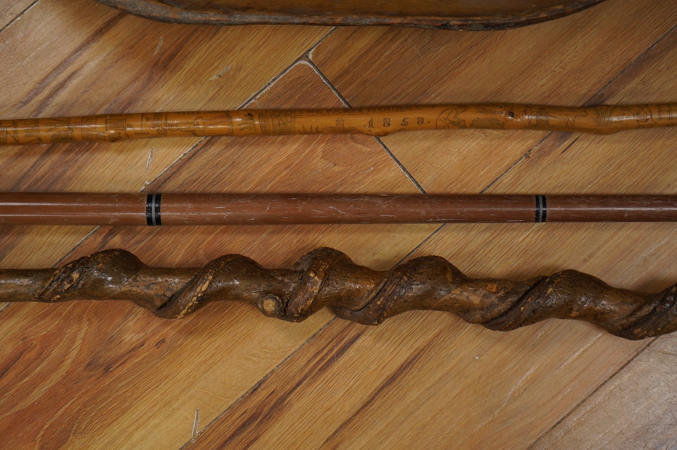 Three novelty walking sticks and gouged gathering bowl. Condition - fair